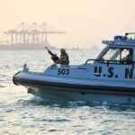 U.S. Navy patrol boat with armed crew on the water