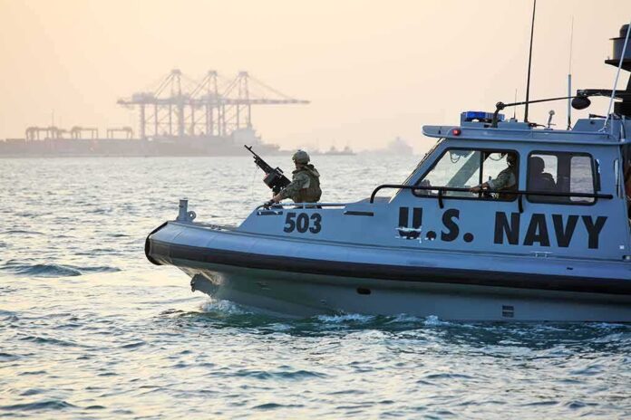 shutterstock_389280448 U.S. Navy patrol boat with armed crew on the water