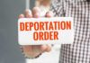 Appeals Court Cripples Fast Deportations Hand holding a card with bold red text