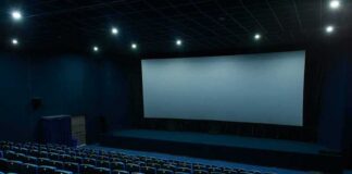 Empty movie theater auditorium with large screen