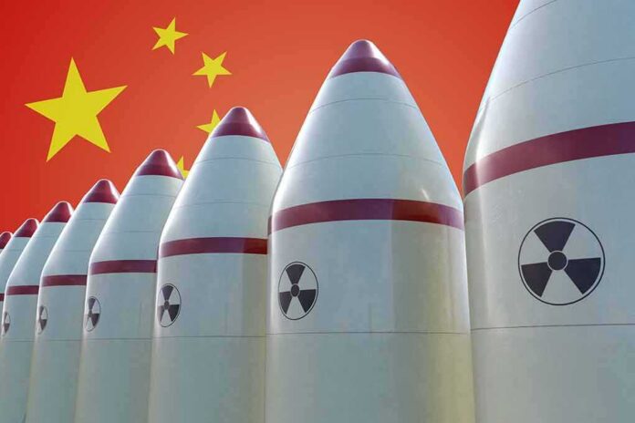 Row of nuclear missiles with radiation symbols before a red flag with yellow stars