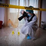forensic photographer documenting indoor crime scene