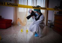 forensic photographer documenting indoor crime scene