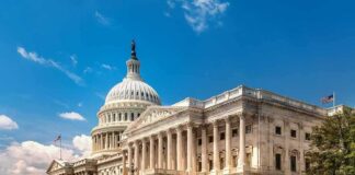 United States Capitol building with dome and columns under a blue sky