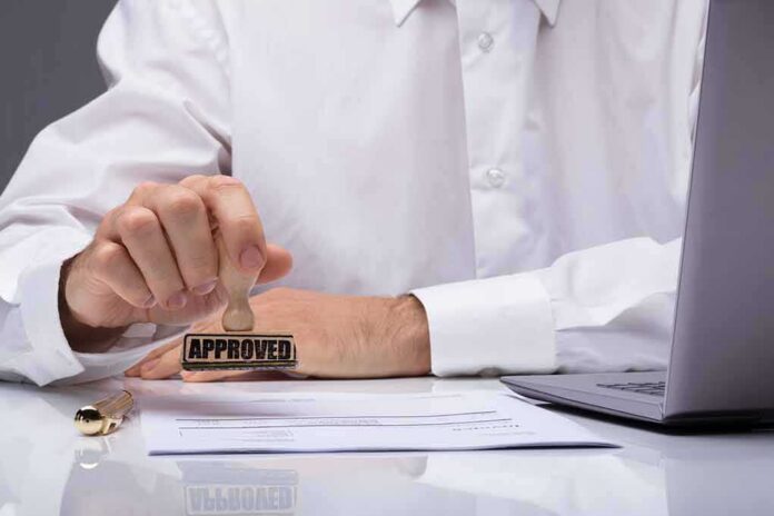Person stamping an approved mark on a document