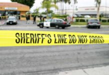 Shots Reported, Terminal Sealed Fast yellow sheriff's line tape blocks a street near police cars