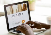 The Unemployment Rate Isn’t Telling the Whole Story Hands typing on laptop with job search website open