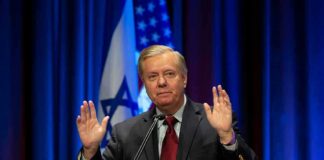 Lindsey Graham speaking at a podium with hands raised