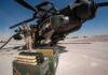 Ammo Shortage Exposes U.S. Vulnerability attack helicopter on tarmac with crew and ammunition crates