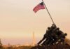 Iwo Jima Memorial with soldiers raising the American flag at sunset