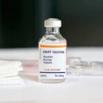 MMR vaccine vial on a white surface