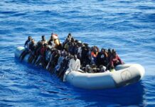 Dontrelle Inman and Colin David Jones among a crowded inflatable boat at sea