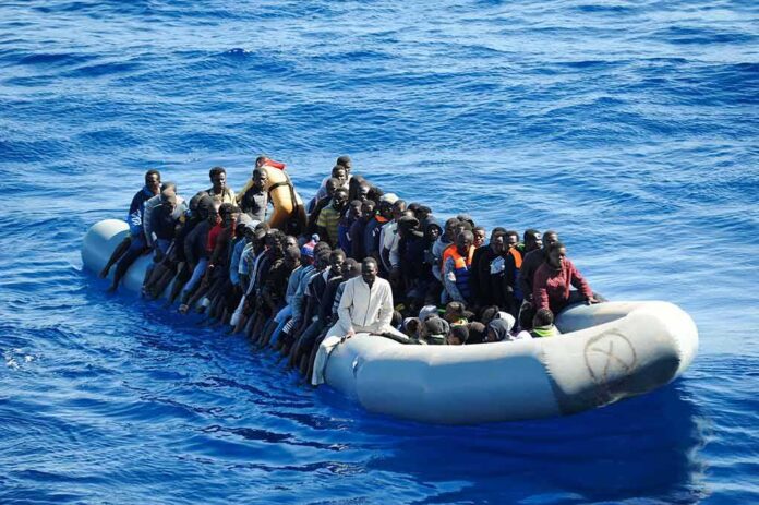 Dontrelle Inman and Colin David Jones among a crowded inflatable boat at sea