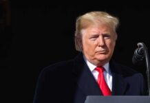 Missile Pause Play? Trump Dangles Kim Meet Donald Trump at a podium with a microphone