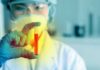 Scientist holding a test tube with red liquid
