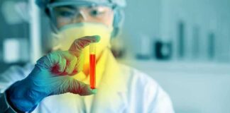 Scientist holding a test tube with red liquid
