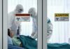One Flight Just Expanded a Deadly Outbreak’s Reach Healthcare workers in hazmat suits treat a patient in a quarantine room
