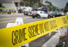Bend School Nightmare – Unlikely Hero Emerges crime scene tape stretches across a blocked city street