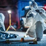 forensic investigators at nighttime crime scene