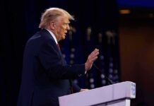 Million-Dollar Trap For Ballot Fraud Donald Trump speaking at a podium with hand raised