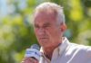 Man speaking into a microphone outdoors