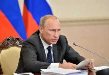 Policy Whiplash: Moscow Fuels America Vladimir Putin speaking at a meeting with documents and a microphone