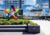 Mall entrance with colorful star sculpture and mirrored facade