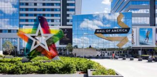 Mall entrance with colorful star sculpture and mirrored facade