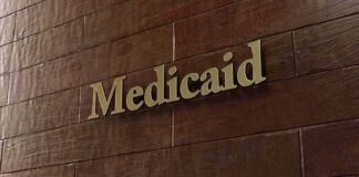 Medicaid sign on a brown wooden wall