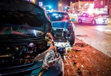 MAGA Terror Tale Crumbles Under Police Reports Wrecked cars at night crash scene with police lights
