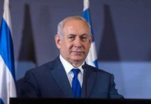 A Pre-Election Warning Has Israel on Alert man in suit at podium with microphones