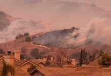 Recovery Funds, Survivors Left Waiting Wildfire burns on hillside near suburban homes