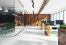 Modern open-plan office with wood accents and glass meeting room